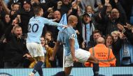 Manchester City's Belgian defender Vincent Kompany (R) celebrates scoring the opening goal during the English Premier League football match between Manchester City and Leicester City at the Etihad Stadium in Manchester, north west England, on May 6, 2019.