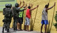 Army soldiers check people during a military police strike over wages while patrolling the streets of Vila Velha Espirito Santo, Brazil, February 11, 2017. Reuters/Paulo Whitaker