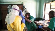 Health workers wear protective equipment as they prepare to attend to suspected Ebola patients at Bikoro Hospital in the Democratic Republic of Congo on May 12, 2018. AFP / UNICEF / Mark Naftalin