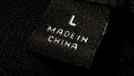 A photo illustration shows a label inside an item of clothing reading 