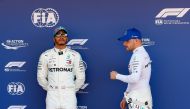 Mercedes' Finnish driver Valtteri Bottas (R) and Mercedes' British driver Lewis Hamilton pose after taking the top two positions following the qualifying session at the Circuit de Catalunya in Montmelo in the outskirts of Barcelona on May 11, 2019 ahead o