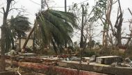 A police officer rests as he sits on a damaged wall following Cyclone Fani in Puri, in the eastern state of Odisha, India, May 5, 2019. (REUTERS/Jatindra Dash)