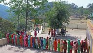 Women stand in a queue to cast their vote at a polling station in village Bhudi in the northern state of Haryana, India, May 12, 2019. (REUTERS/Ajay Verma)