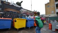 A homeless man working as a tourist guide for social enterprise Unseen Tours points at a street-art installation near Brick Lane, London on November 11, 2017. Umberto Bacchi / Thomson Reuters Foundation