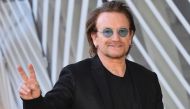 U2 singer Bono flashes the Victory sign upon his arrival at the European Council in Brussels on October 10, 2018. AFP / Emmanuel Dunand