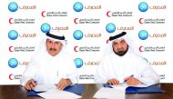 QIB’s Board Member and Head of Zakat Committee, Mansour Al Muslah (right), and Qatar Red Crescent Society Secretary-General, Ali bin Hassan Al Hammadi, signing the cooperation agreement.