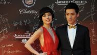 Hong Kong singer Joey Yung (L) and Chinese actor Hu Ge pose on the red carpet during the opening ceremony for the 15th Shanghai International Film Festival on June 16, 2012. AFP / Peter Parks
 