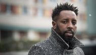French director Ladj Ly poses under the snow on February 27, 2018 during a portrait session in the 
