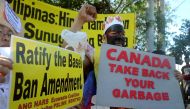 This file photo taken on September 9, 2015, shows environmental activists rallying outside the Philippine Senate in Manila to demand that scores of containers filled with household rubbish be shipped back to Canada. AFP / JAY DIRECTO
