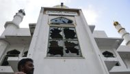 A Muslim man stands in front of the Jumha mosque after a mob attack in Minuwangoda on May 14, 2019. / AFP / LAKRUWAN WANNIARACHCHI 