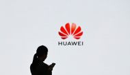 (FILES) In this file photo taken on March 6, 2019, a staff member of Huawei uses her mobile phone at the Huawei Digital Transformation Showcase in Shenzhen, China's Guangdong province. AFP / WANG ZHAO