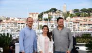 British director Edward Watts, Syrian director and producer Waad al-Kateab and Syrian actor Hamza al-Kateab pose during a photocall for the film 