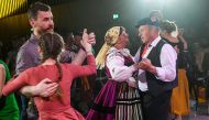 A Polish couple dressed in traditional costumes and others dance the country's mazurka folk dance in Warsaw on April 26, 2019.  AFP / Janek Skarzynski