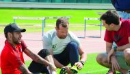 Neymar (left) is assisted by Aspetar experts as he checks a shoe model in this file picture.
