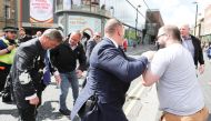Brexit Party leader Nigel Farage gestures after being hit with a milkshake while arriving for a Brexit Party campaign event in Newcastle, Britain, May 20, 2019. REUTERS/Scott Heppell