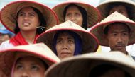 Indonesian farmers attend a large protest over land reform and other agricultural issues in central Jakarta, June 8, 2004. Reuters/Darren Whiteside