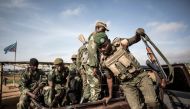Soldiers of the Armed Forces of the Democratic Republic of the Congo (FARDC) prepare to escort health workers attached to ebola response programs on May 18, 2019 in Butembo, north of Kivu.  AFP / John Wessels .

