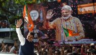 Maharastra state's Chief Minister Devendra Fadnavis waves towards supporters of Indian Prime Minister Narendra Modi and his ruling Bharatiya Janata Party (BJP) as they celebrate on the election results day outside the BJP headquarters in Mumbai on May 23,