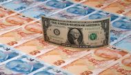 FILE PHOTO: A U.S. dollar banknote is seen on top of 50 and 100 Turkish lira banknotes in this picture illustration in Istanbul, Turkey August 14, 2018. REUTERS/Murad Sezer/Illustration