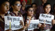 Indian students hold candles as they pay tribute to the students died in a fire in a building in India housing a college in Surat, at a school in Amritsar on May 25, 2019. AFP / NARINDER NANU