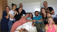 Amanda Eller, a yoga instructor who went missing for 17 days while hiking in Maui's Makawao Forest Reserve, poses for a photo from her hospital bed with her peers at Maui Memorial Medical Center in Hawaii, U.S., after she was rescued during a search opera