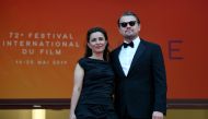 US actor Leonardo DiCaprio (R) and US director Leila Conners pose as they arrive for the screening of the film 