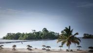 A person sits on a chair on the artificial beach of the Sofitel Hotel, in Sipopo, nearly 16km from Malabo in Equatorial Guinea, on April 20, 2019. AFP / Camille Malplat  

