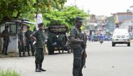 Sri Lankan army soldiers stands guard at a checkpoint on a roadside during special cordon-and-search operations in Colombo on May 25, 2019. AFP / LAKRUWAN WANNIARACHCHI