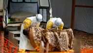 :FILE PHOTO: Health workers dressed in protective suits carry a Congolese woman confirmed to have Ebola as she is admitted to the Ebola treatment centre in Butembo, Democratic Republic of Congo, March 28, 2019. REUTERS/Baz Ratner