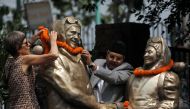 Minister for Information and Communication Technology Gokul Prasad Baskota along with the daughter of Edmund Hillary, Sarah Hillary offer garland to the statues of Edmund Hillary and Tenzing Norgay Sherpa, the first mountaineers to conquer Mount Everest i