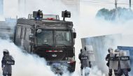 Riot police confront demonstrators during a protest in Tegucigalpa on May 30, 2019. Teachers' and medical doctors' unions joined by students protested against the privatisation of education and health and demand the resignation of Honduran President Juan 