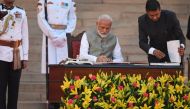 Narendra Modi signs documents after taking the oath of office as India's Prime Minister at the President house in New Delhi on May 30, 2019. / AFP / PRAKASH SINGH 