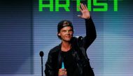Avicii accepts the favorite electronic dance music artist award at the 41st American Music Awards in Los Angeles, California November 24, 2013. Reuters/Lucy Nicholson