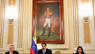 Venezuela's President Nicolas Maduro (C) delivering a speech next to Vice-president Delcy Rodriguez (R) and the President of the Constituent Assembly Diosdado Cabello (L) during a meeting with members of the National Defense Council at Miraflores Presiden