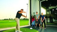 A professional golfer offers tips to student golfers at the Centre of Excellence at the Education City Golf Club.