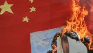 Activists burn a mock Chinese flag with a map of the South China sea during a protest in front of the Chinese consulate in Manila on June 12, 2019, against the Asian superpower's growing sway in the Philippines and as tensions rise over Beijing's presence