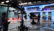 In this file photo taken on September 14, 2017, technicians wait on the set before the broadcast news of the French TV channel France 2 in Paris. AFP / Jacques Demarthon 