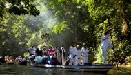 FILE PHOTO: Roman Catholic pilgrims travel in a boat as they accompany the statue of Our Lady of Conception during an annual river procession and pilgrimage along the Caraparu River in Santa Izabel do Para, in the Amazon jungle December 8, 2012. Picture t