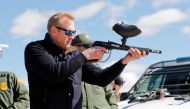 Acting Secretary of Defense Patrick Shanahan fires a modified painted ball gun that shoots pepper balls during a tour of the US-Mexico border at Santa Teresa Station in Sunland Park, New Mexico, February 23, 2019. Pablo Martinez Monsivais/Pool via Reuters