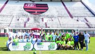 Generation Amazing, United Nations Office on Drugs and Crime and Flamengo FC officials pose for a photograph with the participants of the football development session for impoverished youth in Rio de Janeiro, Brazil, on Tuesday.
