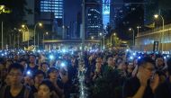 Protesters hold up their phones with lights on during a mass rally to protest against a controversial extradition bill that would allow suspected criminals to be sent to mainland China for trial.  AFP / Yan ZHAO
