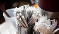 Plastic straws wrapped in paper and plastic forks are seen at a food hall in Washington DC on June 20, 2019. AFP / Eric Baradat 