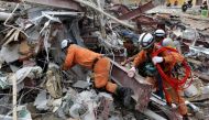 Rescue workers search for victims in the debris a day after an under-construction building collapsed in Sihanoukville on June 23, 2019. / AFP / SUN RETHY Kun
 
