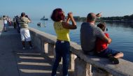 People watch the Russian guided missile frigate Admiral Gorshkov entering Havana's bay, Cuba, June 24, 2019. Reuters/Alexandre Meneghini