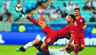 Qatar’s Boualem Khoukhi and Argentina’s Sergio Aguero struggle for the ball during the Copa America tournament group match at the Gremio Arena in Porto Alegre, Brazil, on Sunday.