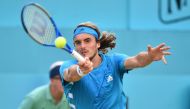 Greece's Stefanos Tsitsipas returns to Canada's Felix Auger Aliassime during their men's singles quarter final tennis match at the ATP Fever-Tree Championships tournament at Queen's Club in west London on June 21, 2019. / AFP / Glyn Kirk 