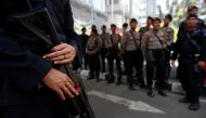 Riot-policeman stands guard with tear gas gun at Indonesia's Constitutional Court, ahead of a verdict of challenge to overturn the official result of the April's presidential election, in Jakarta, Indonesia, June 27, 2019. Reuters/Willy Kurniawan