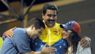  In this file photo taken on April 06, 2013, Venezuelan acting President Nicolas Maduro (C) embraces his wife Cilia Flores (L) and son Nicolas Maduro during a campaign rally in Puerto Ordaz, Bolivar state, Venezuela.  AFP / Juan Barreto
 