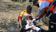 Health team evacuate an injured protestor after Israeli security forces' intervention to a protest against the U.S.-led conference in Bahrain, at Beit El checkpoint in Ramallah, West Bank on June 25, 2019. (?ssam Rimawi/Anadolu Agency)