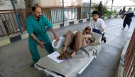 Men transport an injured man to a hospital after a blast in Kabul, Afghanistan July 1, 2019. REUTERS/Mohammad Ismail